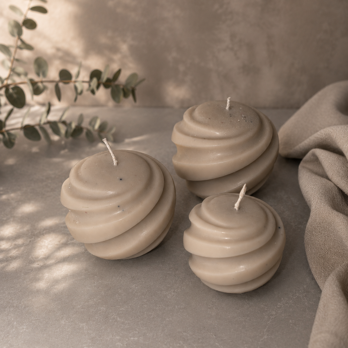 Close up of the spiral texture on a sage green sphere candle